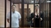BELARUS -- Belarusian opposition figures Maryya Kalesnikava and Maksim Znak, charged with extremism and trying to seize power illegally, stand inside a defendants' cage as they attend a court hearing in Minsk, September 6, 2021